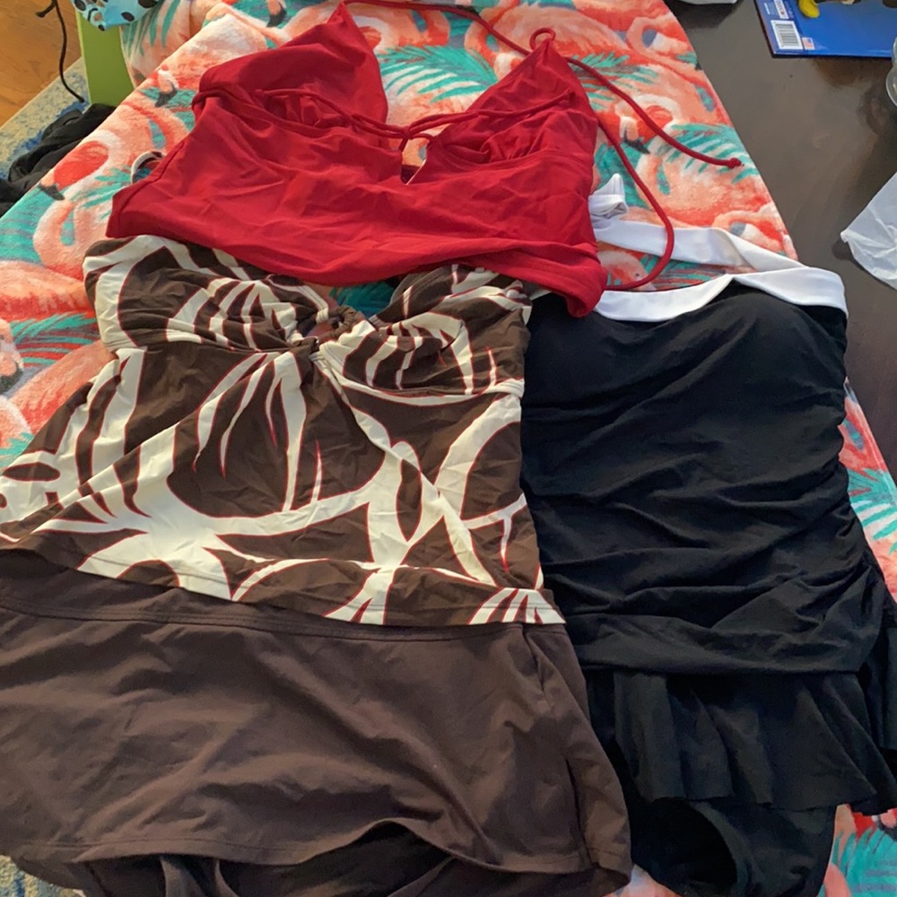 2 bathing suits and 1 tankini top. Sizes 12 and 14.